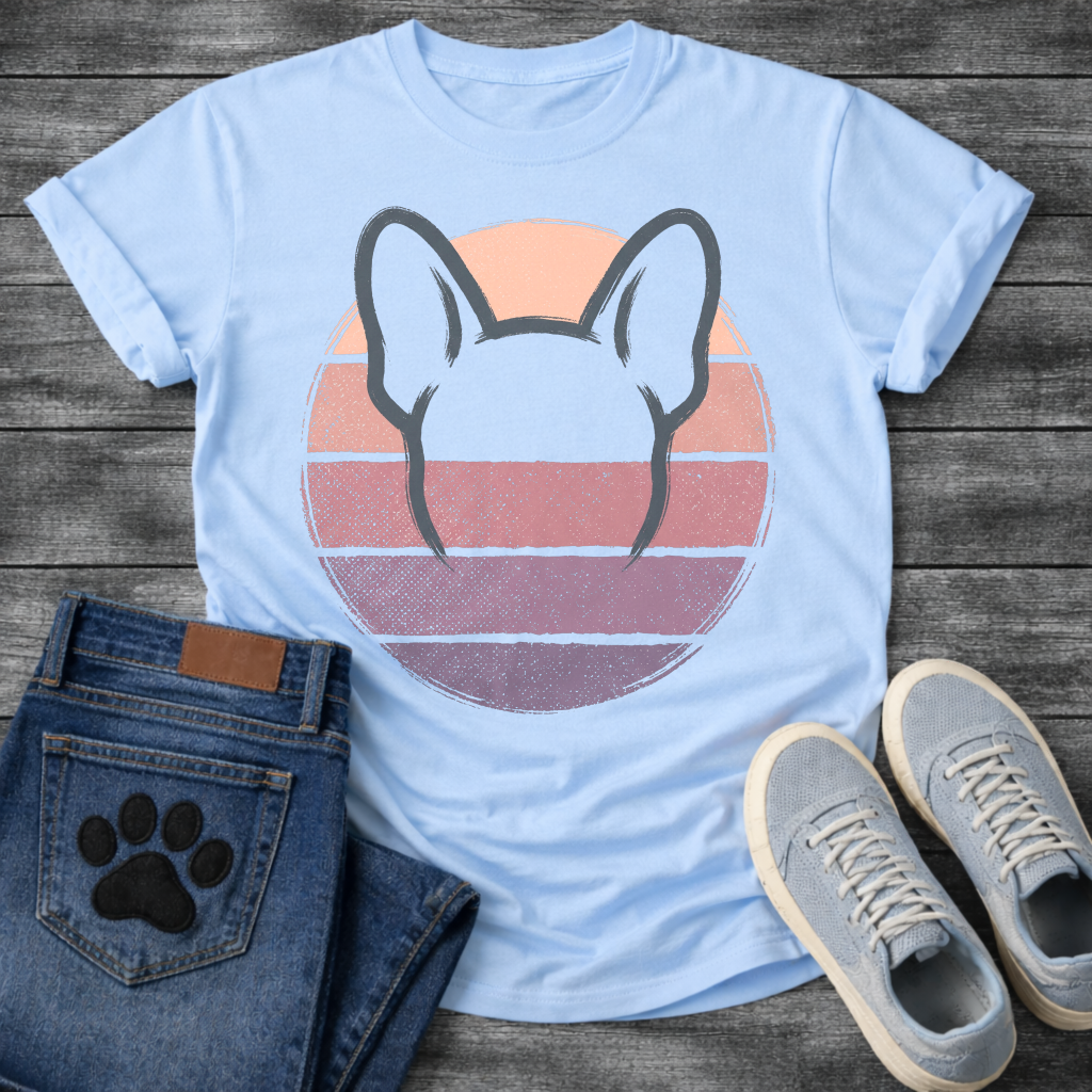 French Bulldog t-shirt with minimal brush ink Frenchie head seen from behind, bold bat ears outlined against a retro striped circle sunset in blush pink mauve and deep purple tones, distressed vintage texture, no text fine art graphic
