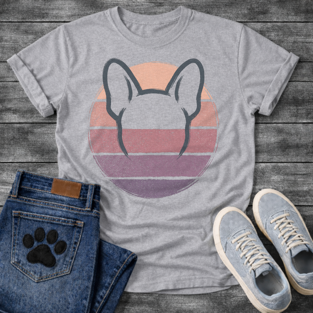 French Bulldog t-shirt with minimal brush ink Frenchie head seen from behind, bold bat ears outlined against a retro striped circle sunset in blush pink mauve and deep purple tones, distressed vintage texture, no text fine art graphic
