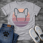 French Bulldog t-shirt with minimal brush ink Frenchie head seen from behind, bold bat ears outlined against a retro striped circle sunset in blush pink mauve and deep purple tones, distressed vintage texture, no text fine art graphic
