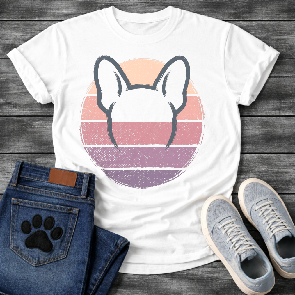 French Bulldog t-shirt with minimal brush ink Frenchie head seen from behind, bold bat ears outlined against a retro striped circle sunset in blush pink mauve and deep purple tones, distressed vintage texture, no text fine art graphic
