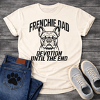 French Bulldog t-shirt with bold collegiate arched text reading Frenchie Dad above a detailed Frenchie portrait, bold italic condensed text reading Devotion Until The End below, single black ink on warm sand tee
