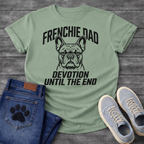French Bulldog t-shirt with bold collegiate arched text reading Frenchie Dad above a detailed Frenchie portrait, bold italic condensed text reading Devotion Until The End below, single black ink on warm sand tee
