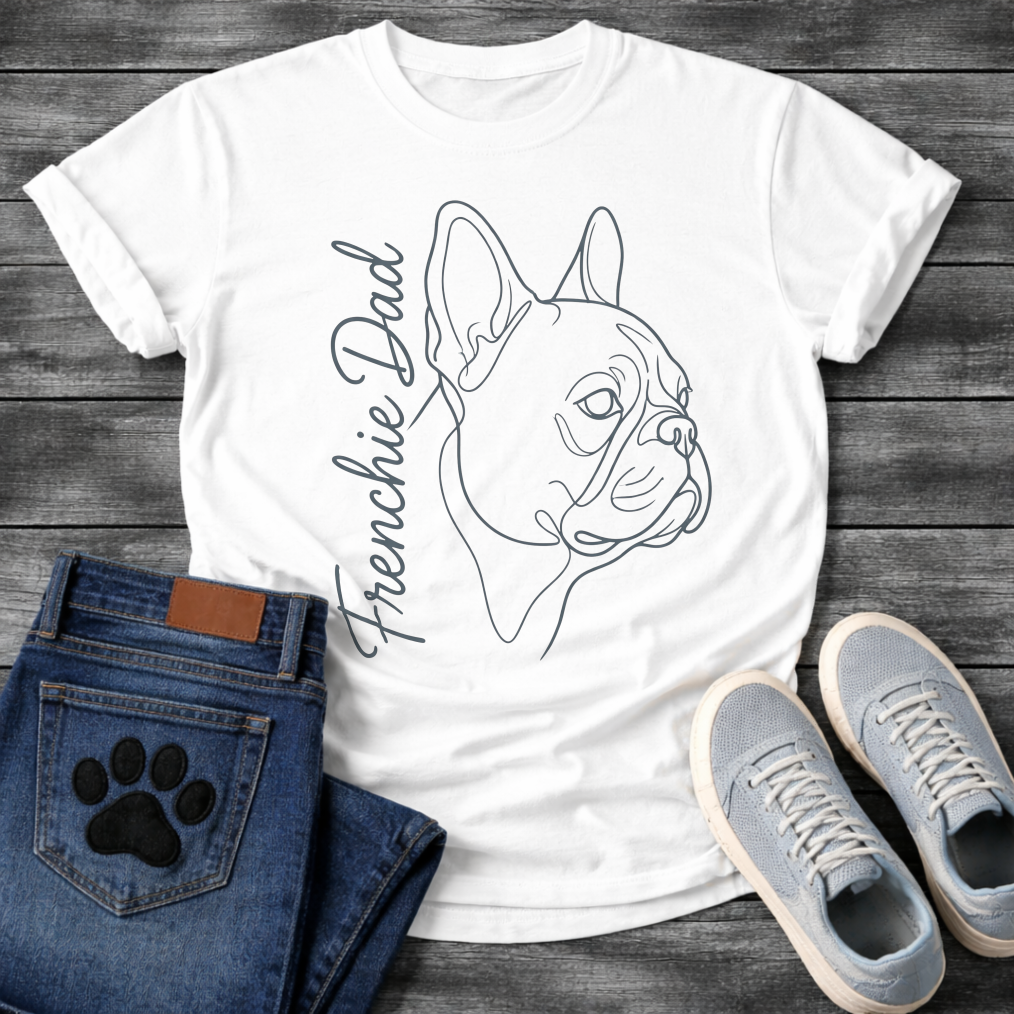 French Bulldog t-shirt with minimal continuous line art Frenchie side profile portrait, flowing script text reading Frenchie Dad alongside, single dark ink on warm sand tee, premium gallery style design