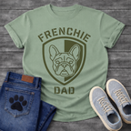 French Bulldog t-shirt with military style shield badge containing a geometric Frenchie face portrait, stencil font arched text reading Frenchie above and Dad below, single olive green ink graphic