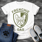 French Bulldog t-shirt with military style shield badge containing a geometric Frenchie face portrait, stencil font arched text reading Frenchie above and Dad below, single olive green ink graphic