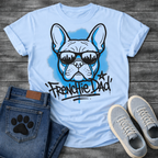 French Bulldog t-shirt with graffiti style Frenchie wearing city skyline sunglasses, electric blue spray paint halo behind the portrait, bold graffiti tag text reading Frenchie Dad with star and blue drip below