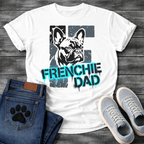 French Bulldog t-shirt with stencil-style Frenchie portrait over distressed dark block background, bold neon cyan graffiti text reading Frenchie Dad with black drip effects, high contrast urban street art graphic on warm sand tee
