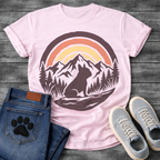 French Bulldog t-shirt with circular badge illustration, Frenchie silhouette sitting on a rocky trail surrounded by pine trees and mountain peaks, retro sunset stripe arch above in terracotta and gold, deep plum border, distressed vintage texture, no text