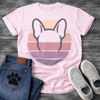 French Bulldog t-shirt with minimal brush ink Frenchie head seen from behind, bold bat ears outlined against a retro striped circle sunset in blush pink mauve and deep purple tones, distressed vintage texture, no text fine art graphic
