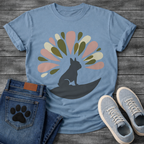 French Bulldog t-shirt with Frenchie silhouette sitting on a crescent moon, abstract teardrop petal burst radiating behind in muted pink olive green and cream tones, no text, soft boho illustration graphic