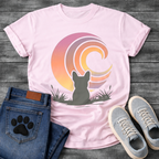 French Bulldog t-shirt with Frenchie silhouette seen from behind sitting in grass and reeds, facing a large swirling spiral sunset in pink orange purple and yellow gradient tones, painterly vintage illustration graphic