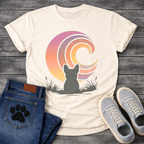 French Bulldog t-shirt with Frenchie silhouette seen from behind sitting in grass and reeds, facing a large swirling spiral sunset in pink orange purple and yellow gradient tones, painterly vintage illustration graphic