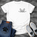 French Bulldog left chest pocket t-shirt with vintage halftone Frenchie face peeking over distressed arched text reading I'm Always Watching You, small dark single-ink graphic on warm sand tee, retro pocket print style