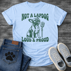 French Bulldog t-shirt with retro groovy arched text reading Not a Lapdog above a detailed Frenchie illustration mid-vocalization beside a vintage microphone, bold text below reading Loud and Proud, single forest green ink graphic