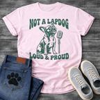 French Bulldog t-shirt with retro groovy arched text reading Not a Lapdog above a detailed Frenchie illustration mid-vocalization beside a vintage microphone, bold text below reading Loud and Proud, single forest green ink graphic