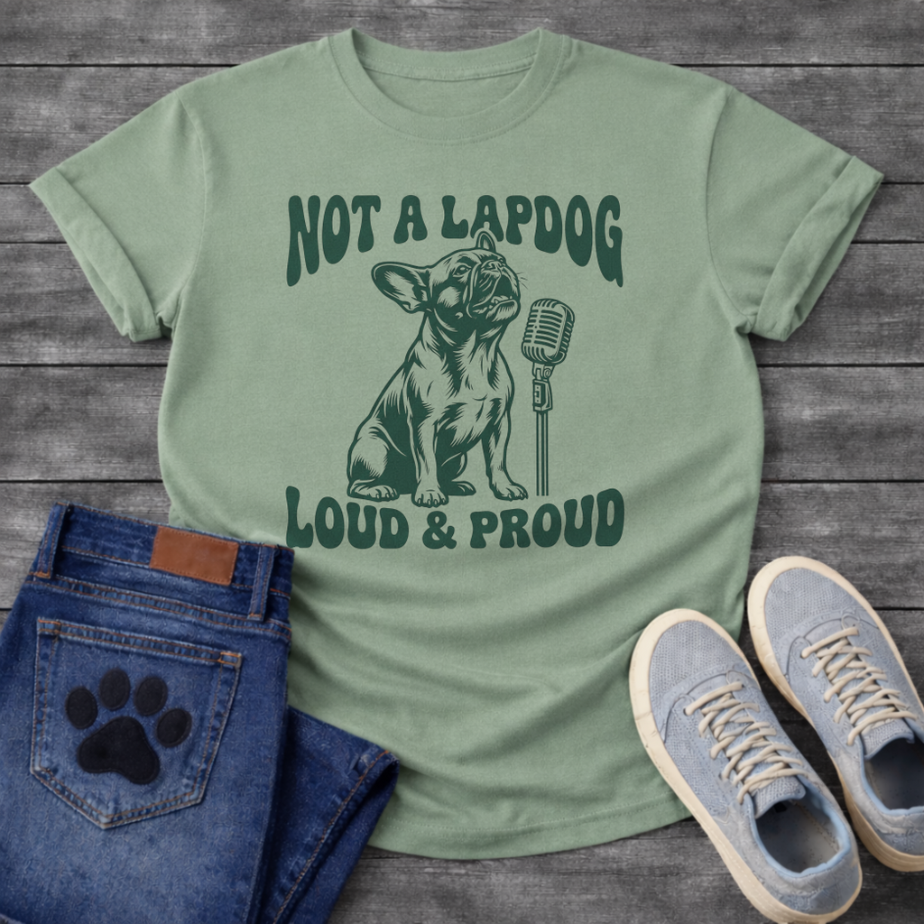 French Bulldog t-shirt with retro groovy arched text reading Not a Lapdog above a detailed Frenchie illustration mid-vocalization beside a vintage microphone, bold text below reading Loud and Proud, single forest green ink graphic