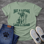French Bulldog t-shirt with retro groovy arched text reading Not a Lapdog above a detailed Frenchie illustration mid-vocalization beside a vintage microphone, bold text below reading Loud and Proud, single forest green ink graphic