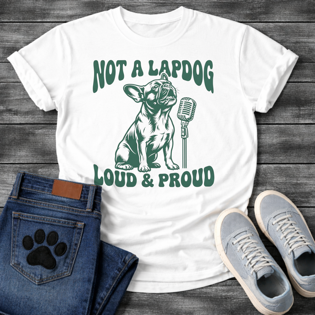 French Bulldog t-shirt with retro groovy arched text reading Not a Lapdog above a detailed Frenchie illustration mid-vocalization beside a vintage microphone, bold text below reading Loud and Proud, single forest green ink graphic