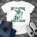 French Bulldog t-shirt with retro groovy arched text reading Not a Lapdog above a detailed Frenchie illustration mid-vocalization beside a vintage microphone, bold text below reading Loud and Proud, single forest green ink graphic