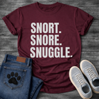 Snort Snore Snuggle bold white typography graphic tee on black