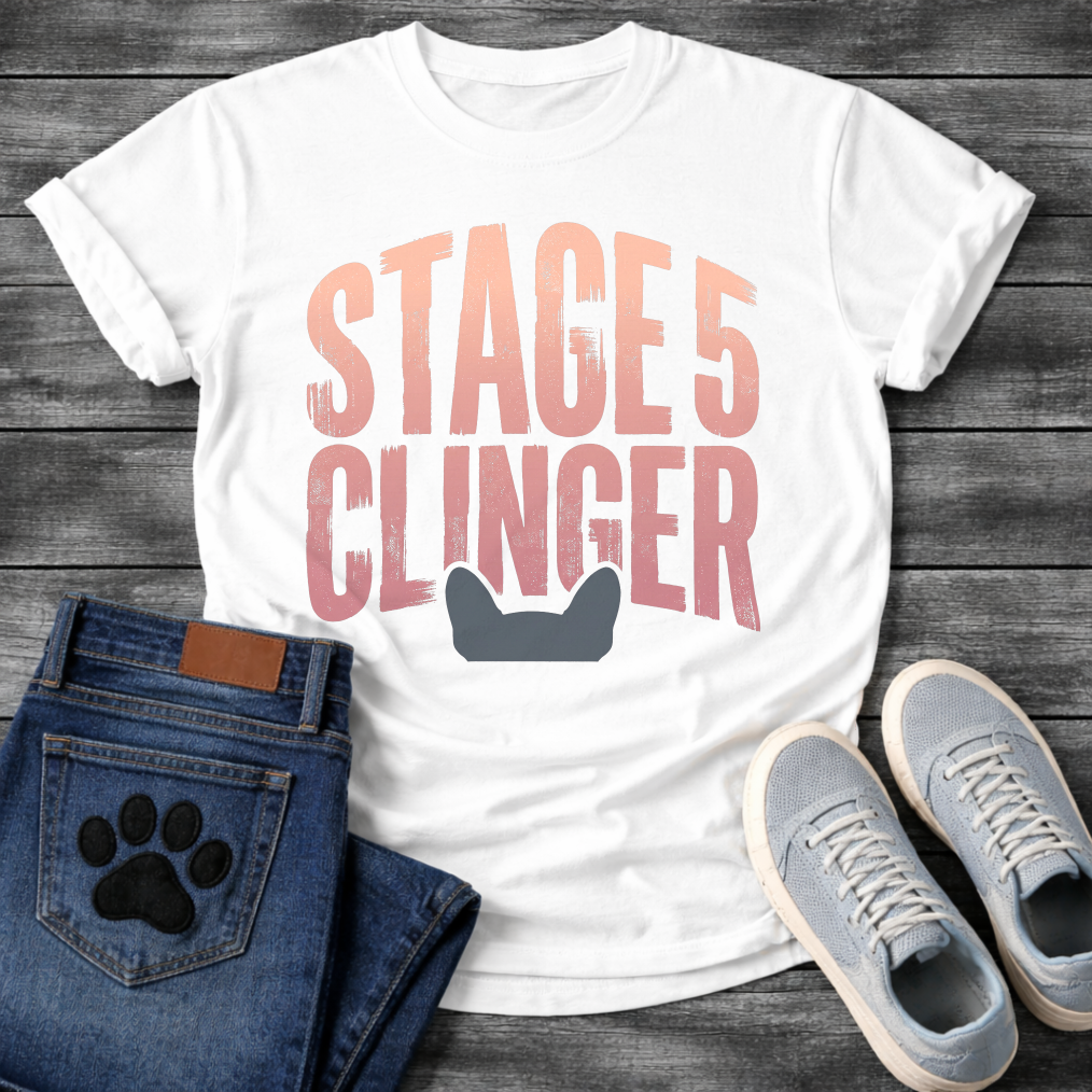 French Bulldog t-shirt with oversized distressed brush typography reading Stage 5 Clinger in dusty rose and mauve tones, small Frenchie head silhouette peeking up from the bottom of the design, no text graphic