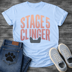 French Bulldog t-shirt with oversized distressed brush typography reading Stage 5 Clinger in dusty rose and mauve tones, small Frenchie head silhouette peeking up from the bottom of the design, no text graphic