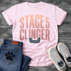 French Bulldog t-shirt with oversized distressed brush typography reading Stage 5 Clinger in dusty rose and mauve tones, small Frenchie head silhouette peeking up from the bottom of the design, no text graphic