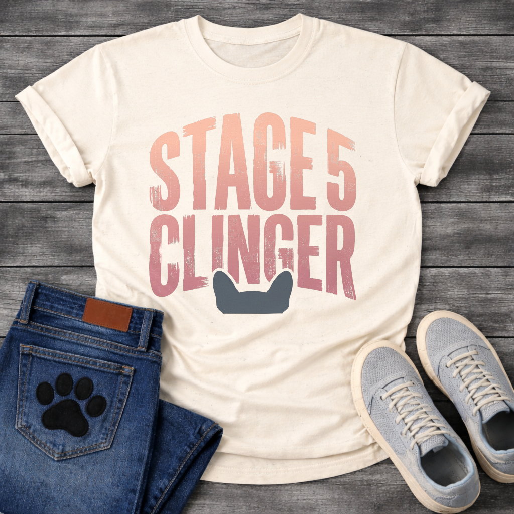 French Bulldog t-shirt with oversized distressed brush typography reading Stage 5 Clinger in dusty rose and mauve tones, small Frenchie head silhouette peeking up from the bottom of the design, no text graphic