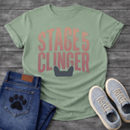 French Bulldog t-shirt with oversized distressed brush typography reading Stage 5 Clinger in dusty rose and mauve tones, small Frenchie head silhouette peeking up from the bottom of the design, no text graphic