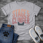 French Bulldog t-shirt with oversized distressed brush typography reading Stage 5 Clinger in dusty rose and mauve tones, small Frenchie head silhouette peeking up from the bottom of the design, no text graphic