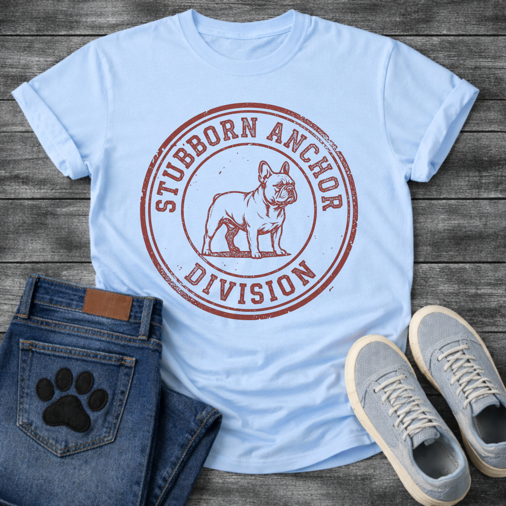 French Bulldog t-shirt with vintage rubber stamp circular badge, detailed Frenchie standing portrait centered, distressed collegiate text reading Stubborn Anchor Division around the border, single terracotta ink with heavy worn texture
