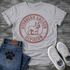 French Bulldog t-shirt with vintage rubber stamp circular badge, detailed Frenchie standing portrait centered, distressed collegiate text reading Stubborn Anchor Division around the border, single terracotta ink with heavy worn texture