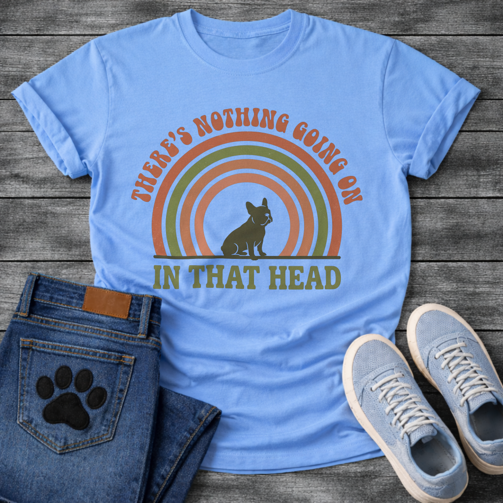 Retro 70s French Bulldog t-shirt with arched groovy text reading There's Nothing Going On In That Head, Frenchie silhouette centered in concentric terracotta and olive green rainbow arcs, vintage distressed style