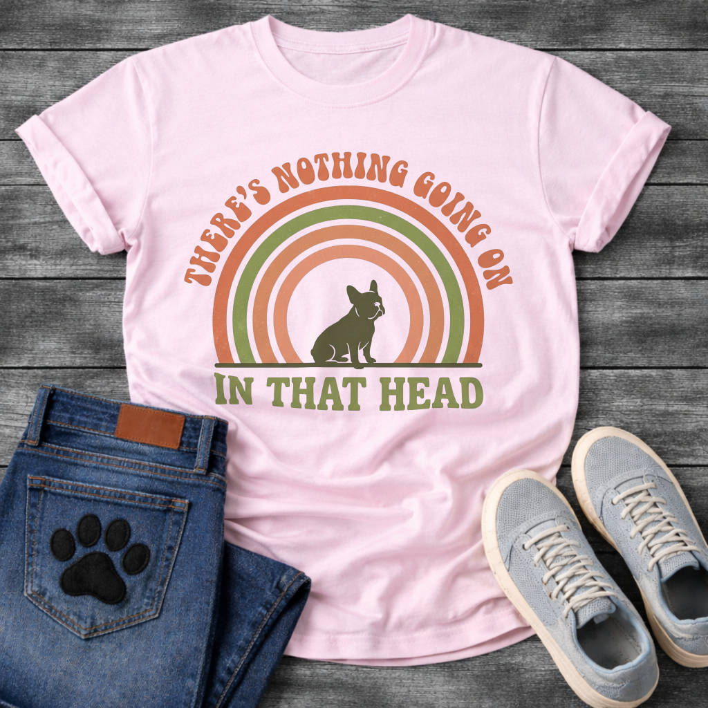 Retro 70s French Bulldog t-shirt with arched groovy text reading There's Nothing Going On In That Head, Frenchie silhouette centered in concentric terracotta and olive green rainbow arcs, vintage distressed style
