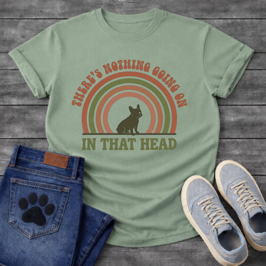 Retro 70s French Bulldog t-shirt with arched groovy text reading There's Nothing Going On In That Head, Frenchie silhouette centered in concentric terracotta and olive green rainbow arcs, vintage distressed style