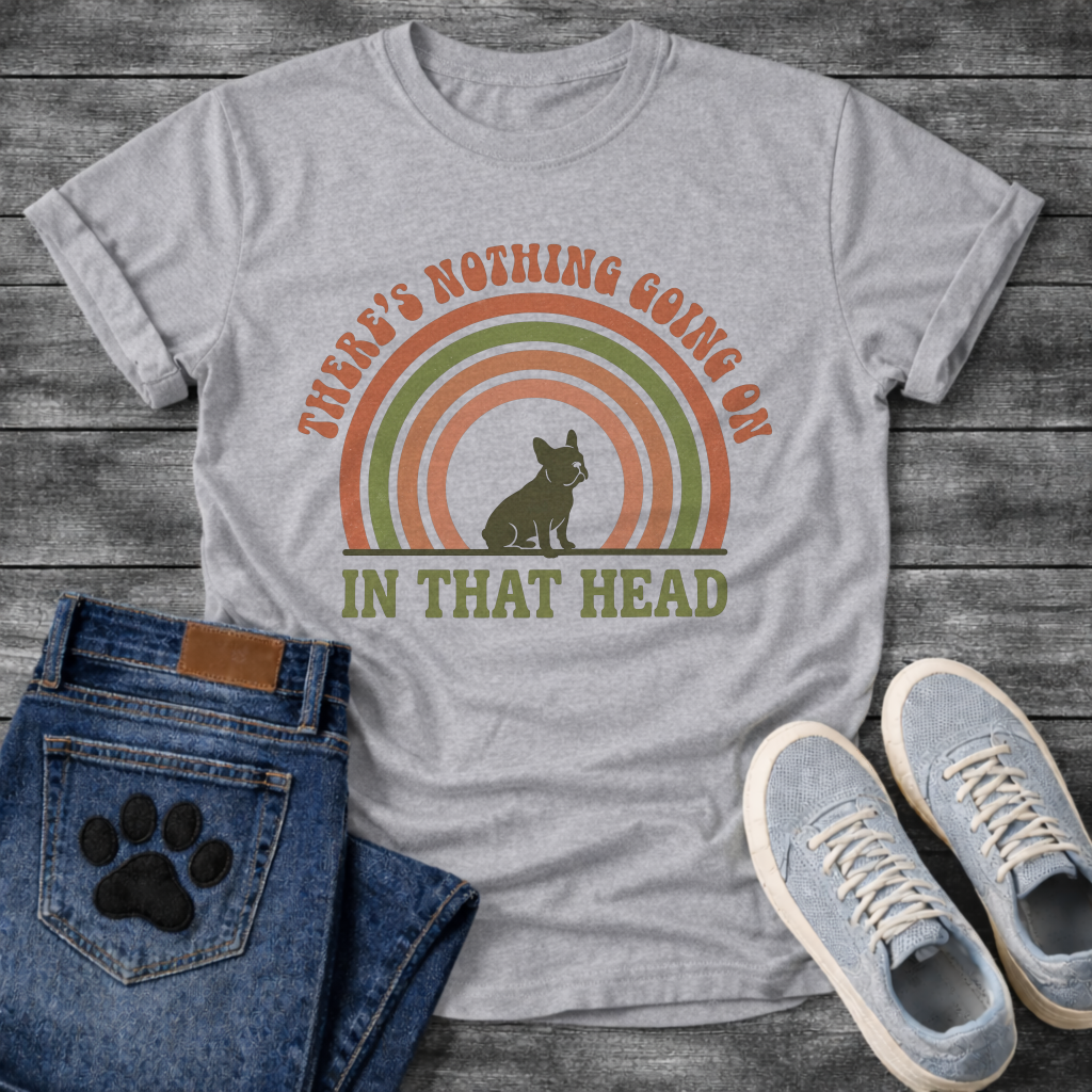 Retro 70s French Bulldog t-shirt with arched groovy text reading There's Nothing Going On In That Head, Frenchie silhouette centered in concentric terracotta and olive green rainbow arcs, vintage distressed style