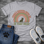Retro 70s French Bulldog t-shirt with arched groovy text reading There's Nothing Going On In That Head, Frenchie silhouette centered in concentric terracotta and olive green rainbow arcs, vintage distressed style