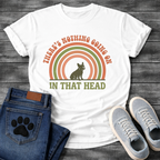 Retro 70s French Bulldog t-shirt with arched groovy text reading There's Nothing Going On In That Head, Frenchie silhouette centered in concentric terracotta and olive green rainbow arcs, vintage distressed style