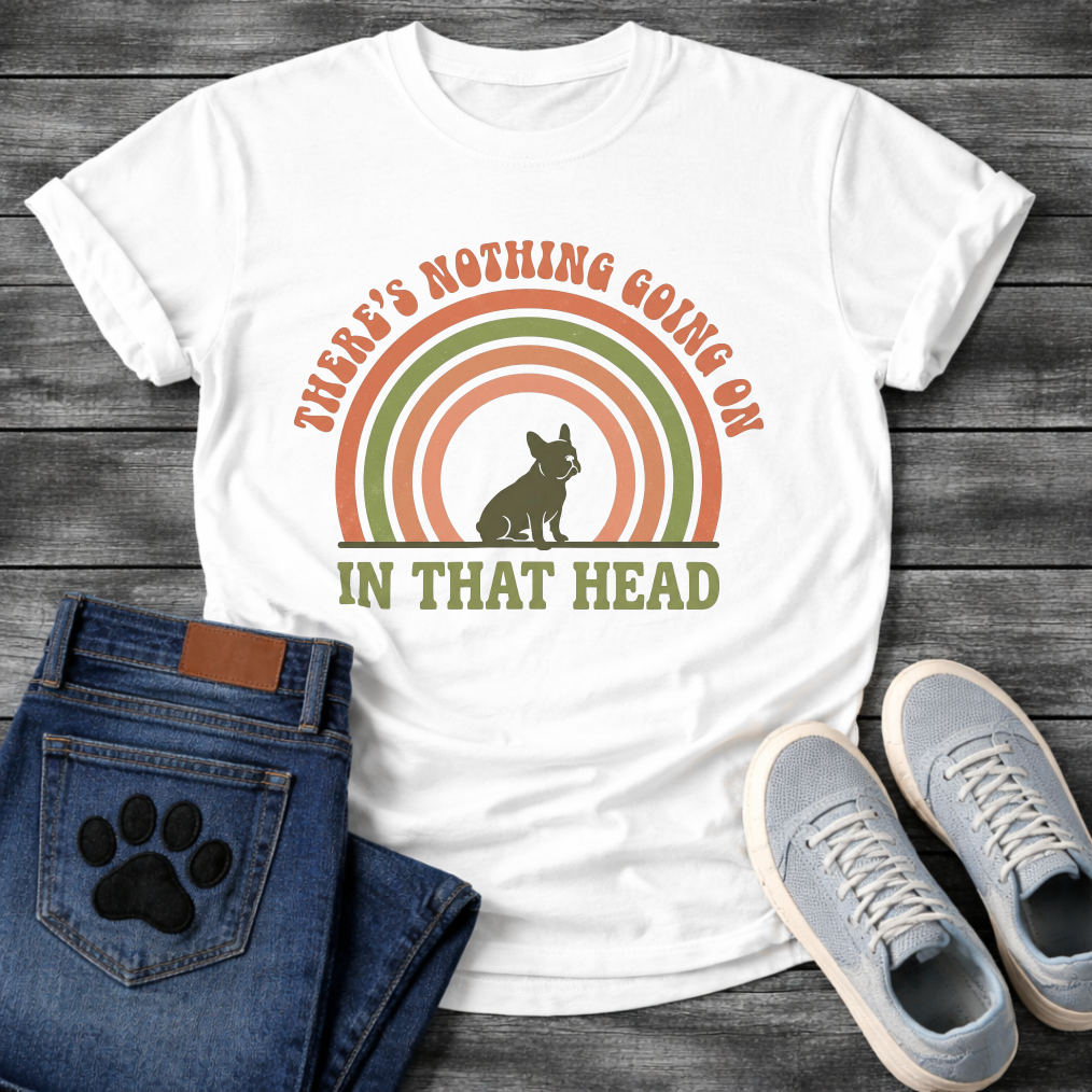 Retro 70s French Bulldog t-shirt with arched groovy text reading There's Nothing Going On In That Head, Frenchie silhouette centered in concentric terracotta and olive green rainbow arcs, vintage distressed style