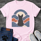 French Bulldog t-shirt with Frenchie silhouette seen from behind centered in a wavy layered landscape of slate blue and terracotta, cream moon rising behind the head, arched frame above, heavy crackle distressed texture throughout, no text earthy art graphic