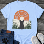 French Bulldog t-shirt with Frenchie silhouette seen from behind sitting in dark green botanical cattails and grass, cream circle moon rising behind the head, bold concentric terracotta arch above, distressed torn edge ground texture, no text boho art graphic
