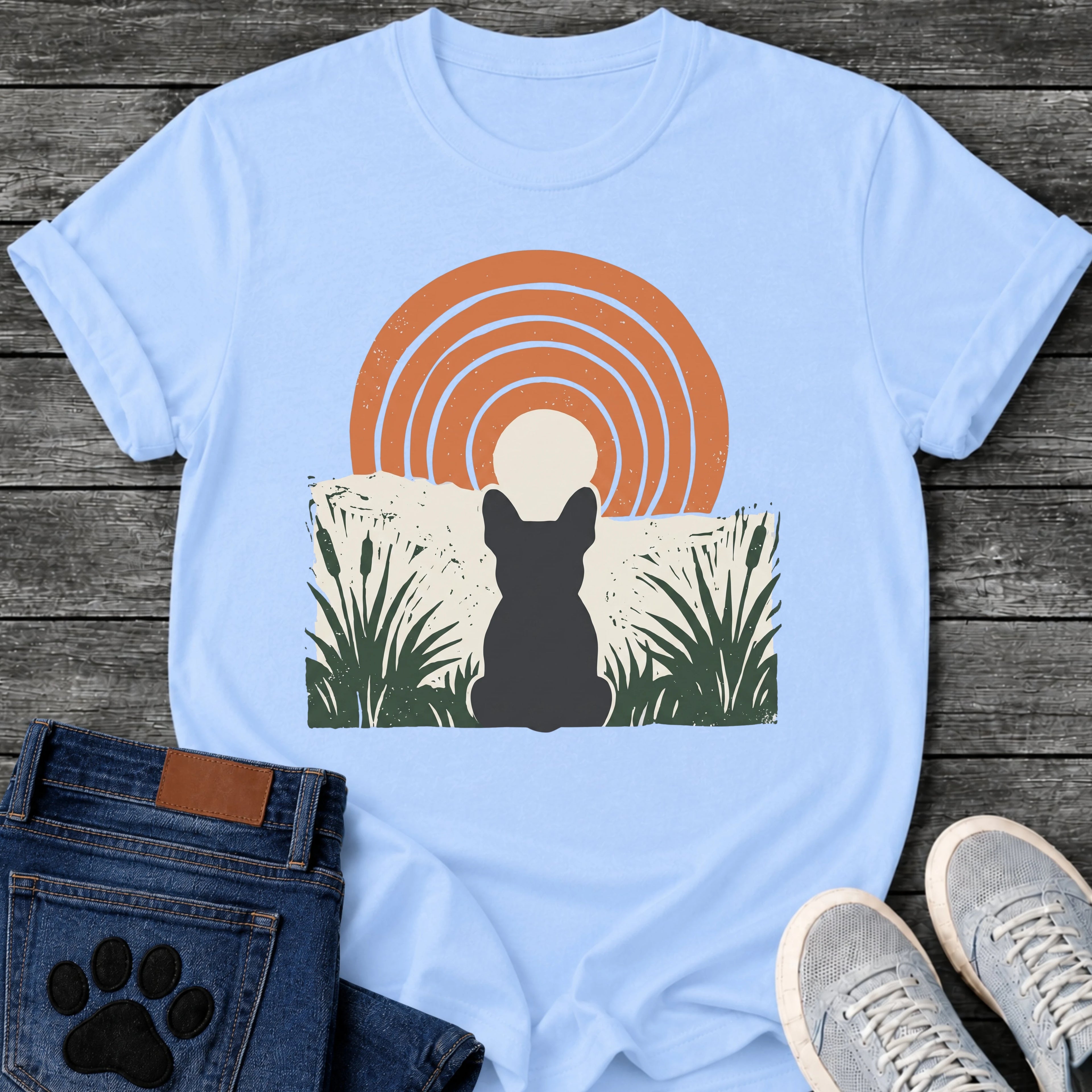 French Bulldog t-shirt with Frenchie silhouette seen from behind sitting in dark green botanical cattails and grass, cream circle moon rising behind the head, bold concentric terracotta arch above, distressed torn edge ground texture, no text boho art graphic
