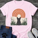 French Bulldog t-shirt with Frenchie silhouette seen from behind sitting in dark green botanical cattails and grass, cream circle moon rising behind the head, bold concentric terracotta arch above, distressed torn edge ground texture, no text boho art graphic
