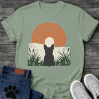 French Bulldog t-shirt with Frenchie silhouette seen from behind sitting in dark green botanical cattails and grass, cream circle moon rising behind the head, bold concentric terracotta arch above, distressed torn edge ground texture, no text boho art graphic
