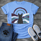 French Bulldog t-shirt with Frenchie silhouette seen from behind centered in a distressed wavy landscape of deep plum teal and cream, double concentric arch with arrow detail above, heavy vintage texture throughout, no text moody art graphic