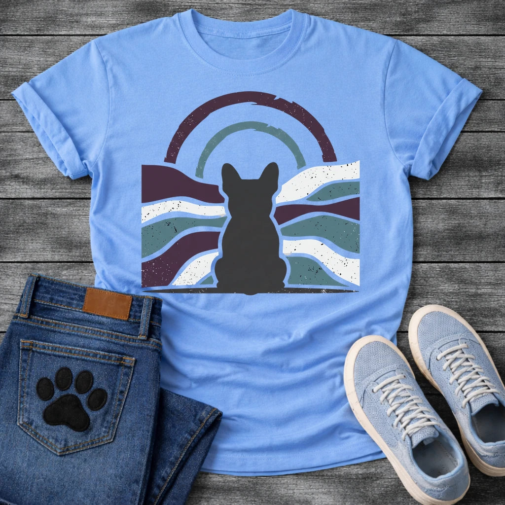 French Bulldog t-shirt with Frenchie silhouette seen from behind centered in a distressed wavy landscape of deep plum teal and cream, double concentric arch with arrow detail above, heavy vintage texture throughout, no text moody art graphic