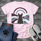 French Bulldog t-shirt with Frenchie silhouette seen from behind centered in a distressed wavy landscape of deep plum teal and cream, double concentric arch with arrow detail above, heavy vintage texture throughout, no text moody art graphic