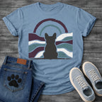 French Bulldog t-shirt with Frenchie silhouette seen from behind centered in a distressed wavy landscape of deep plum teal and cream, double concentric arch with arrow detail above, heavy vintage texture throughout, no text moody art graphic