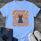 French Bulldog t-shirt with Frenchie silhouette seen from behind on a baseline inside a rounded square, swirling wavy lines filling the frame in terracotta gold and soft purple, terracotta sun arc rising behind the head, distressed texture, no text psychedelic art graphic