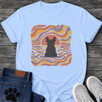 French Bulldog t-shirt with Frenchie silhouette seen from behind on a baseline inside a rounded square, swirling wavy lines filling the frame in terracotta gold and soft purple, terracotta sun arc rising behind the head, distressed texture, no text psychedelic art graphic